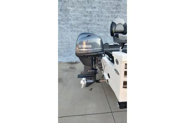 Slide: The Image of 2022 G3 Angler V164 F boat with Yamaha outboard motor, parked on concrete surface. - 12
