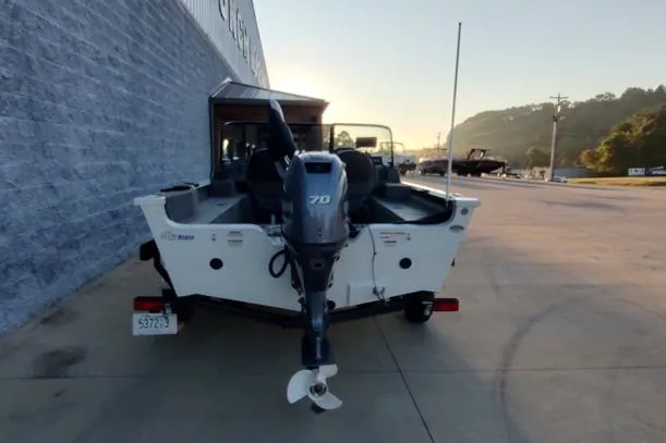 Slide: The Image of 2022 G3 Angler V164 F boat with outboard motor, parked outdoors. - 13