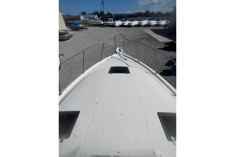 Slide: The Image of 1987 Tiara Yachts 3100 Open boat deck view in a marina setting. - 15