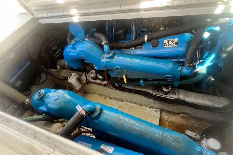 Slide: The Image of Engine compartment of a 1987 Tiara Yachts 3100 Open, featuring blue Crusader 454 engines. - 16