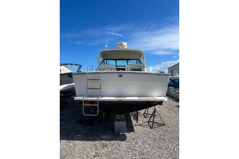 Slide: The Image of 1987 Tiara Yachts 3100 Open on dry dock under clear blue sky. - 4