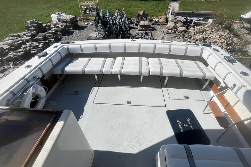 Slide: The Image of 1987 Tiara Yachts 3100 Open boat deck with white seating and outdoor setting. - 5