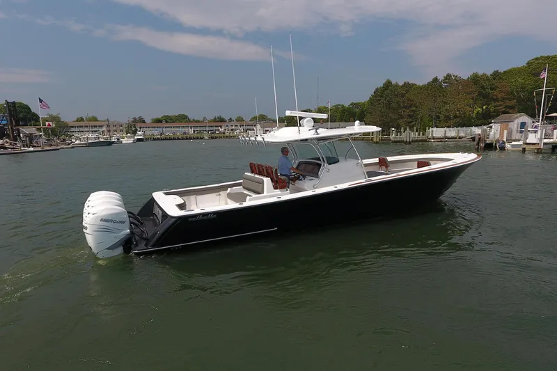 The Image of 2021 Valhalla Boatworks V-41 cruising in a marina, featuring sleek design and powerful engines. - 0