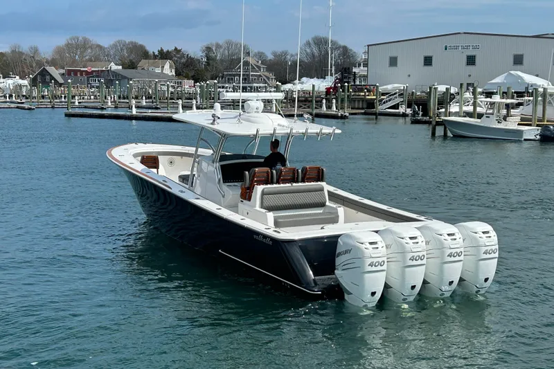 Slide: The Image of 2021 Valhalla Boatworks V-41 with four Mercury 400 engines docked at a marina. - 2