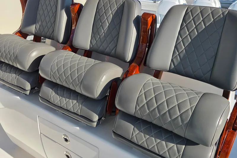 Slide: The Image of 2021 Valhalla Boatworks V-41 deck detail with wood trim and water backdrop. - 17