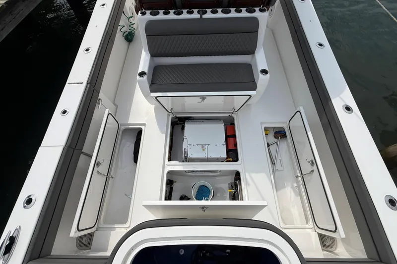 Slide: The Image of 2021 Valhalla Boatworks V-41 luxury boat interior at marina, featuring sleek seating and helm. - 22