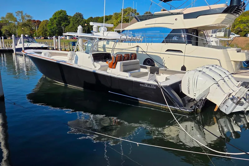 Slide: The Image of 2021 Valhalla Boatworks V-41 docked, featuring sleek design and powerful Mercury engines. - 4