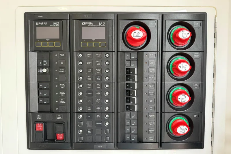 Slide: The Image of Electrical control panel on 2021 Valhalla Boatworks V-41, featuring switches and circuit breakers. - 25