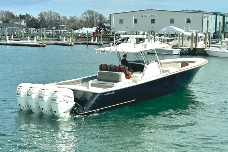 Slide: The Image of 2021 Valhalla Boatworks V-41 with quad Mercury engines in a marina setting. - 1