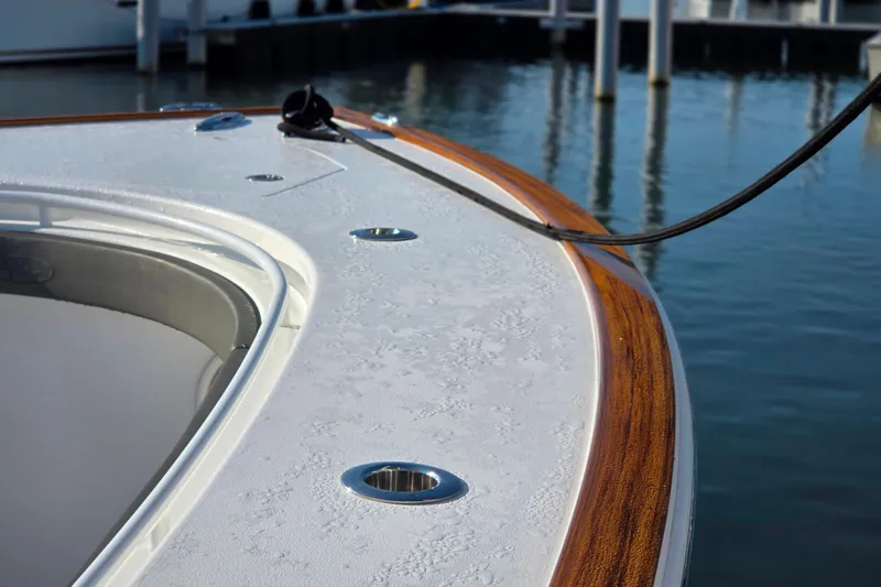 Slide: The Image of 2021 Valhalla Boatworks V-41 deck detail with wood trim and water backdrop. - 19
