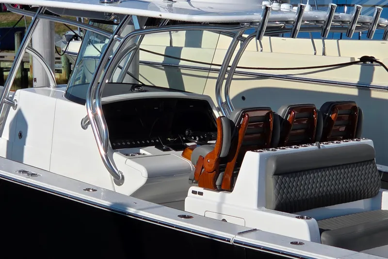 Slide: The Image of 2021 Valhalla Boatworks V-41 bow seating area with luxurious upholstery, docked by the water. - 7