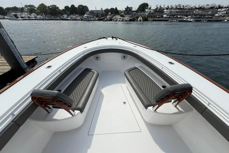 Slide: The Image of 2021 Valhalla Boatworks V-41 bow seating area with luxurious upholstery, docked by the water. - 9