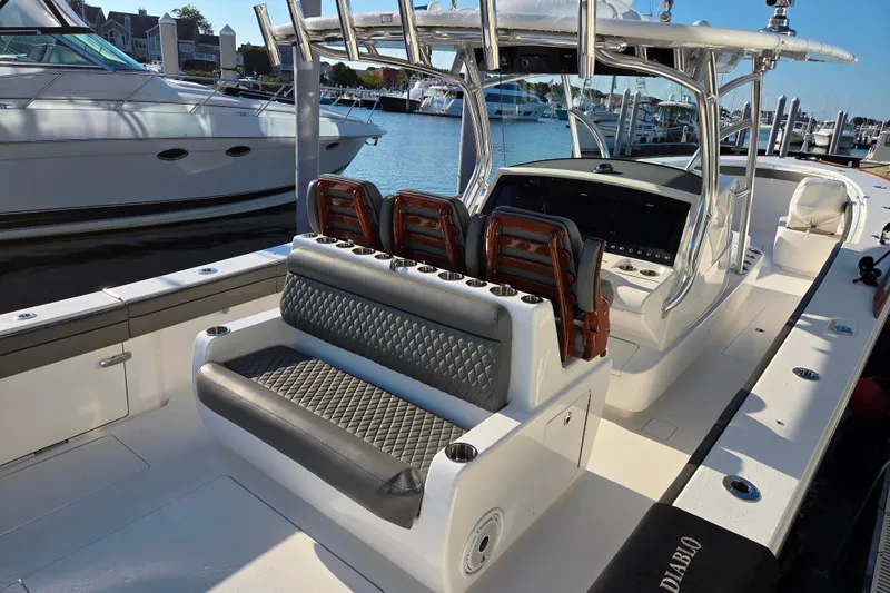 Slide: The Image of 2021 Valhalla Boatworks V-41 luxury boat interior at marina, featuring sleek seating and helm. - 24