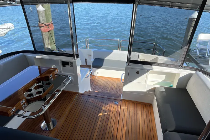 Slide: The Image of Luxurious interior of 2025 Riviera 585 SUV yacht with wooden flooring and seating. - 13