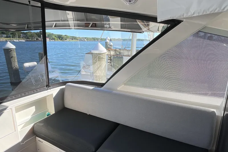 Slide: The Image of 2025 Riviera 585 SUV interior with waterfront view, featuring sleek seating and large windows. - 20