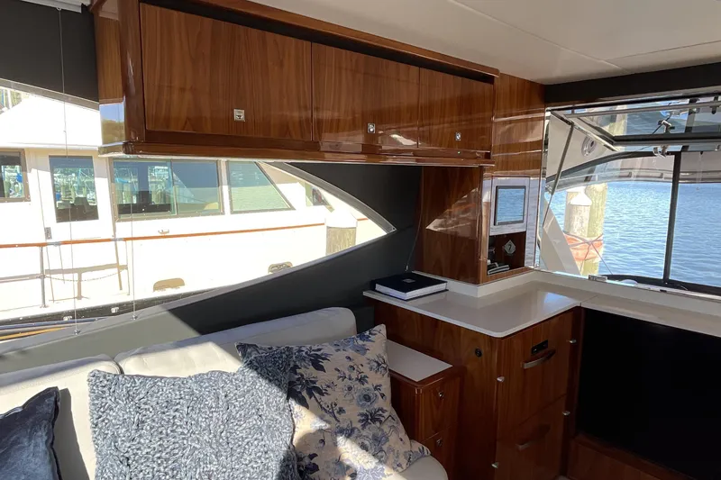 Slide: The Image of Luxurious interior of 2025 Riviera 585 SUV yacht with elegant wood cabinetry and waterfront view. - 24