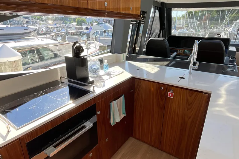Slide: The Image of Luxurious kitchen interior of 2025 Riviera 585 SUV yacht with modern appliances and sleek design. - 32