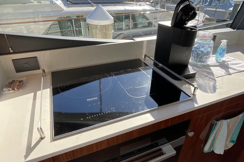 Slide: The Image of Modern kitchen in 2025 Riviera 585 SUV yacht with induction cooktop and coffee machine. - 33
