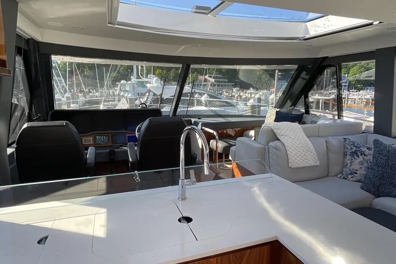 Slide: The Image of Luxurious interior of 2025 Riviera 585 SUV yacht with modern seating and panoramic windows. - 35