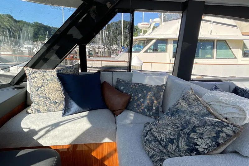 Slide: The Image of Luxurious interior of 2025 Riviera 585 SUV yacht with plush cushions and marina view. - 40