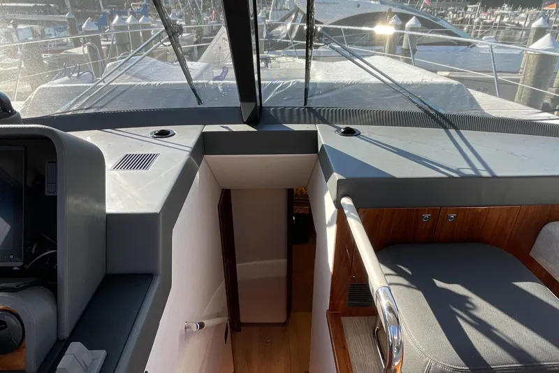Slide: The Image of Interior view of 2025 Riviera 585 SUV yacht cockpit with modern design and marina background. - 47
