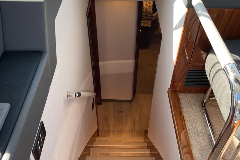 Slide: The Image of Interior staircase of 2025 Riviera 585 SUV yacht, featuring elegant wood and modern design. - 48