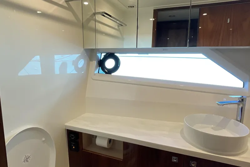 Slide: The Image of Luxurious bathroom interior of 2025 Riviera 585 SUV yacht, featuring modern fixtures and sleek design. - 57