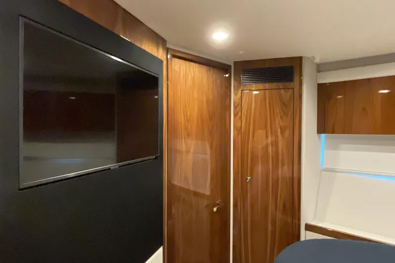 Slide: The Image of Interior of 2025 Riviera 585 SUV with sleek wood paneling and mounted TV. - 65