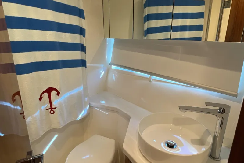 Slide: The Image of Modern bathroom in 2025 Riviera 585 SUV yacht with nautical-themed decor. - 71