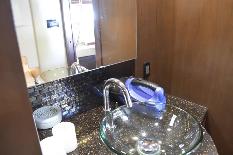 Slide: The Image of 2013 Regal 42 Sport Coupe boat seating area with cup holders on deck. - 10