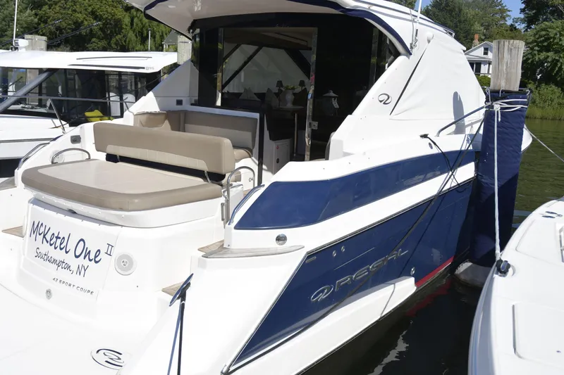 Slide: The Image of 2013 Regal 42 Sport Coupe yacht on calm water, side view. - 2