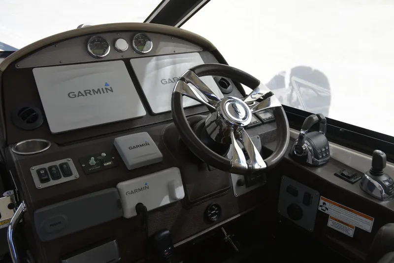 Slide: The Image of 2013 Regal 42 Sport Coupe helm with Garmin navigation and modern controls. - 20
