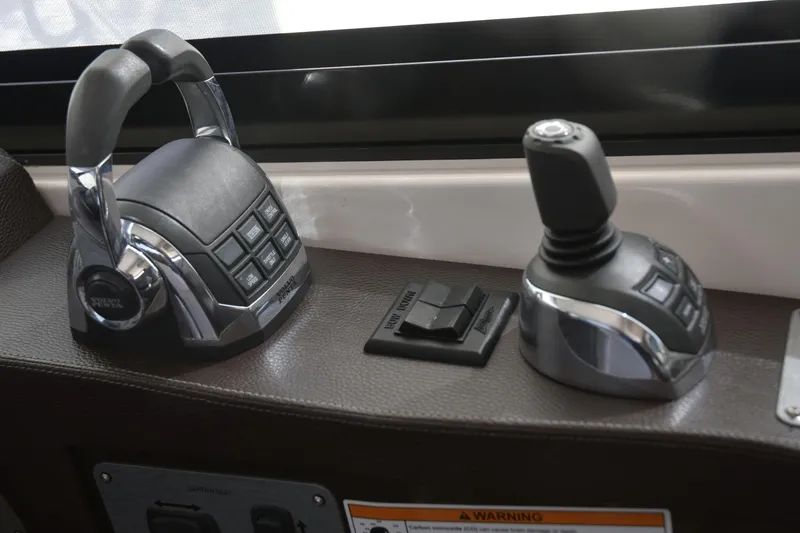 Slide: The Image of Control panel of 2013 Regal 42 Sport Coupe with joystick and throttle levers. - 22