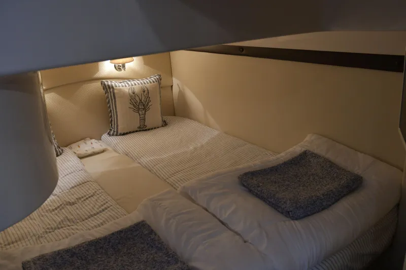 Slide: The Image of Cozy cabin interior of 2013 Regal 42 Sport Coupe with twin beds and nautical decor. - 36