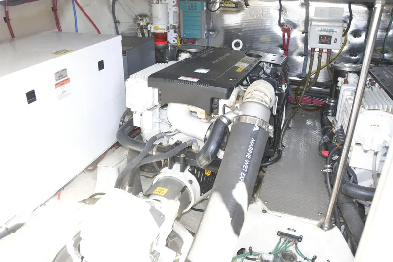 Slide: The Image of Engine room of a 2013 Regal 42 Sport Coupe, showcasing marine equipment and components. - 39