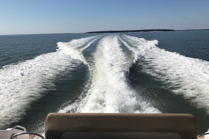 Slide: The Image of Wake trail behind 2013 Regal 42 Sport Coupe on open water. - 43