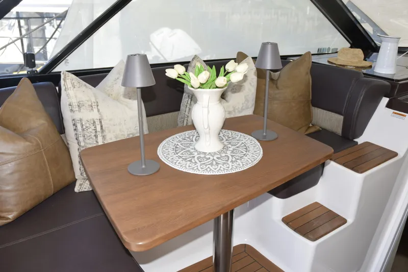 Slide: The Image of 2013 Regal 42 Sport Coupe yacht docked, featuring sleek design and comfortable seating. - 5