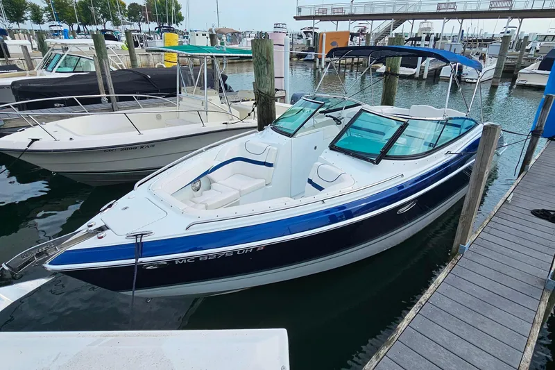 The Image of 2011 Formula 290 Bowrider boat docked in marina, featuring sleek design and spacious seating. - 0