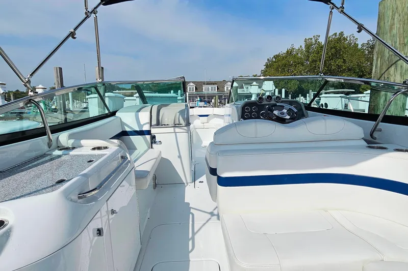 Slide: The Image of 2011 Formula 290 Bowrider boat interior with white seating and modern dashboard. - 10