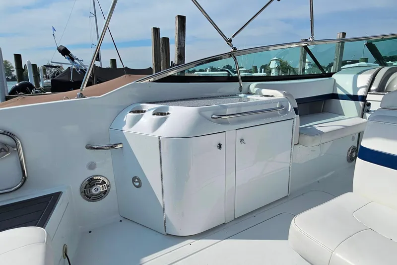 Slide: The Image of 2011 Formula 290 Bowrider interior with seating and storage, docked at marina. - 11