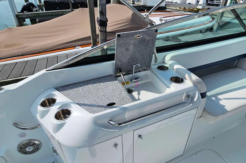Slide: The Image of 2011 Formula 290 Bowrider boat interior with sink and cup holders. - 12