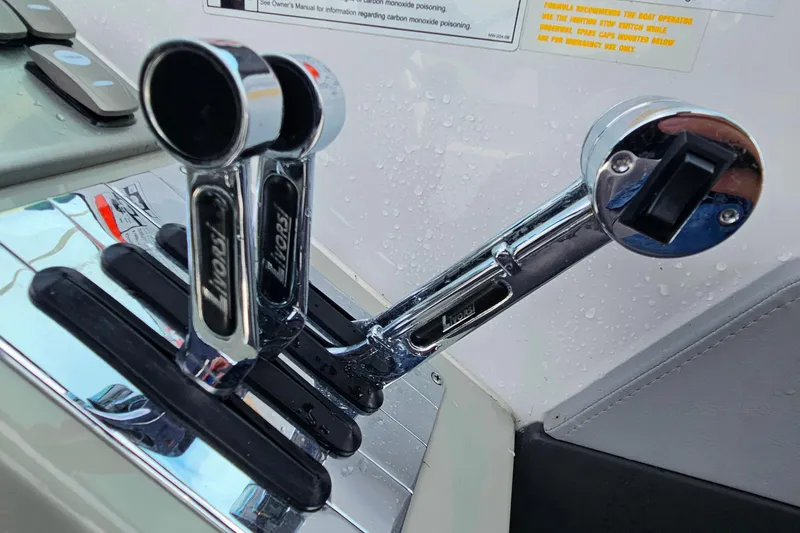Slide: The Image of Chrome throttle controls on a 2011 Formula 290 Bowrider boat dashboard. - 16