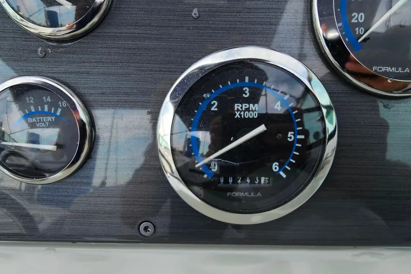 Slide: The Image of Dashboard gauges of a 2011 Formula 290 Bowrider boat, showing RPM and battery voltage. - 17