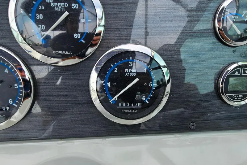 Slide: The Image of Dashboard of a 2011 Formula 290 Bowrider showing speed, RPM, and temperature gauges. - 18