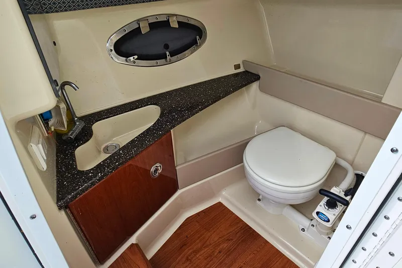 Slide: The Image of 2011 Formula 290 Bowrider bathroom with sink, toilet, and wood accents. - 22