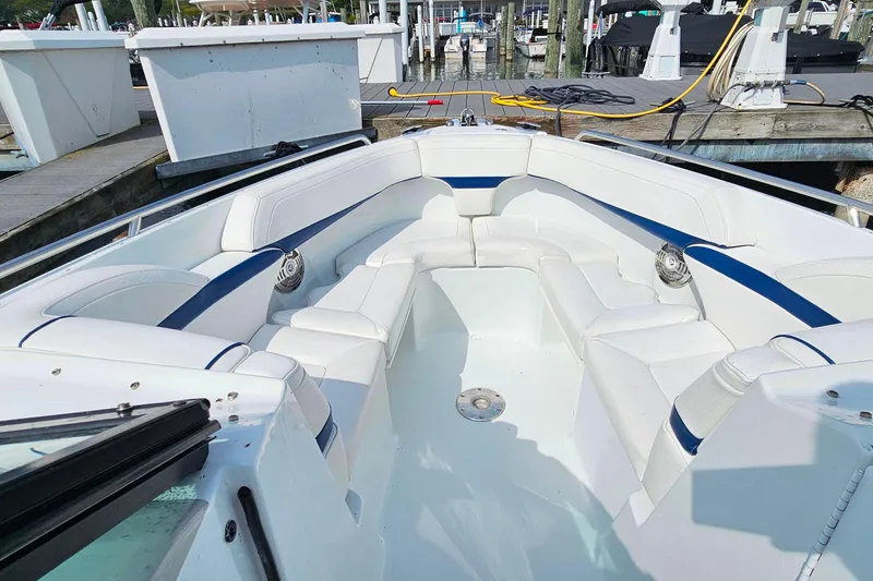 Slide: The Image of 2011 Formula 290 Bowrider with spacious white seating at a marina dock. - 26