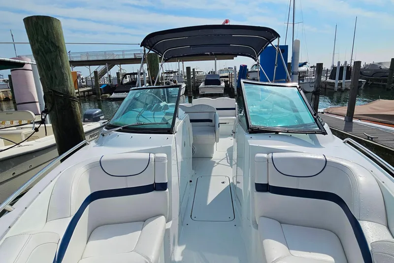 Slide: The Image of 2011 Formula 290 Bowrider boat docked, featuring spacious seating and sleek design. - 27