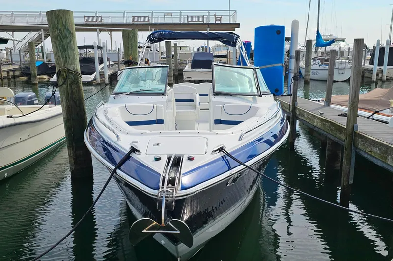 Slide: The Image of 2011 Formula 290 Bowrider docked at marina, featuring sleek design and spacious seating. - 3