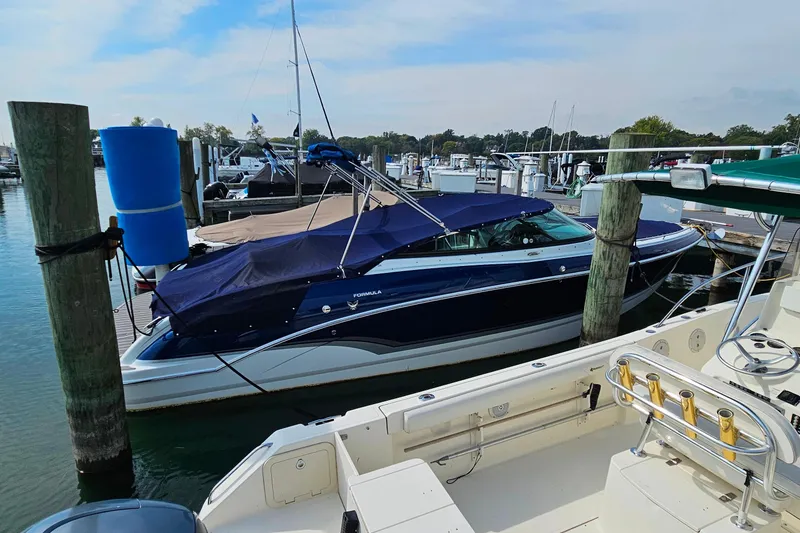Slide: The Image of 2011 Formula 290 Bowrider docked at marina, covered with blue canopy. - 30