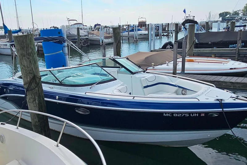 Slide: The Image of 2011 Formula 290 Bowrider docked at a marina, featuring sleek design and blue accents. - 32